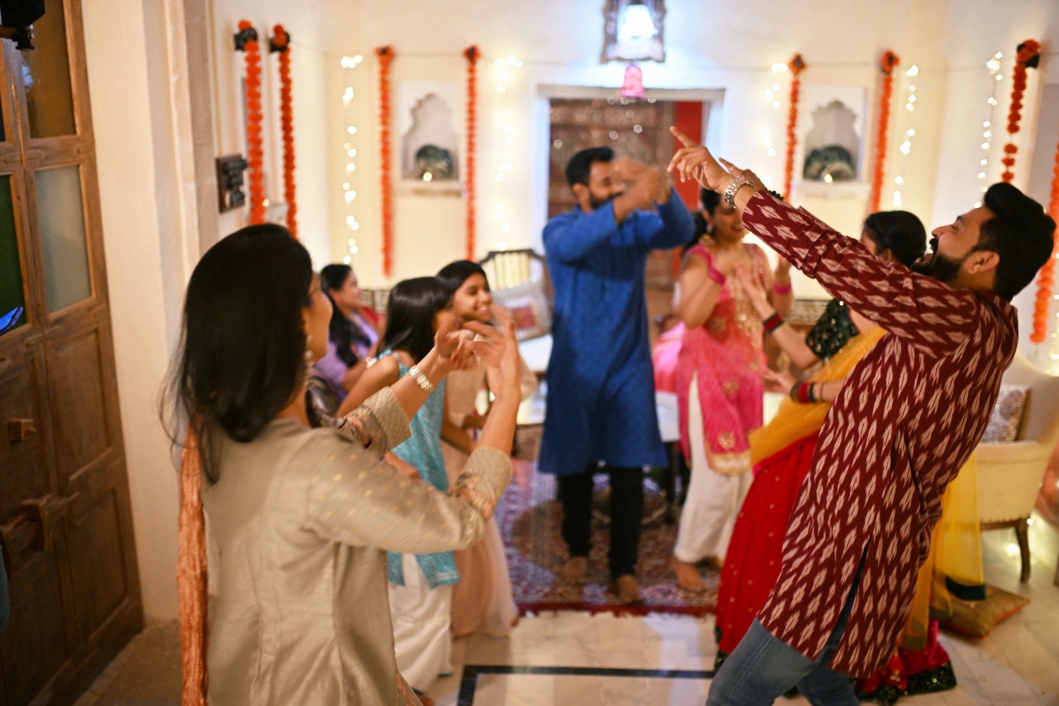 Indian family dancing together during celebration