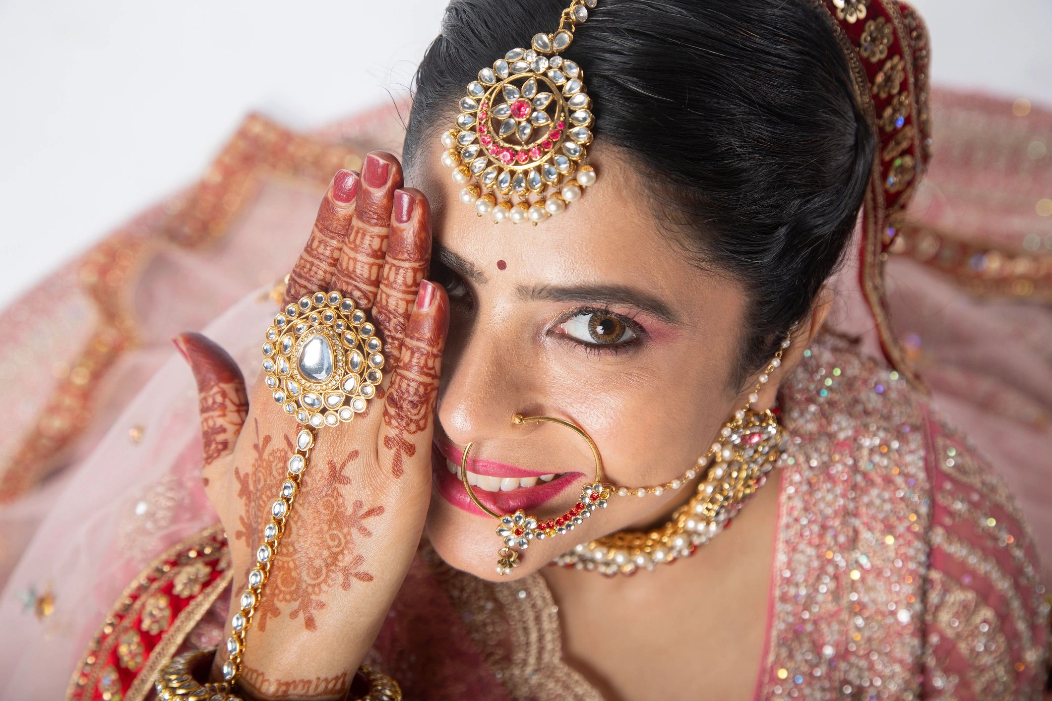 Bride portrait with mehndi-adorned hand